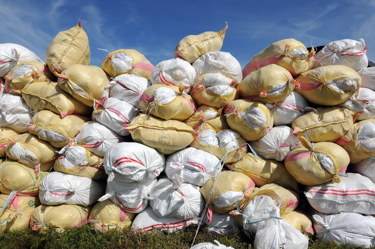 Stacked woven sacks of graded grain ready for export — processing and packing